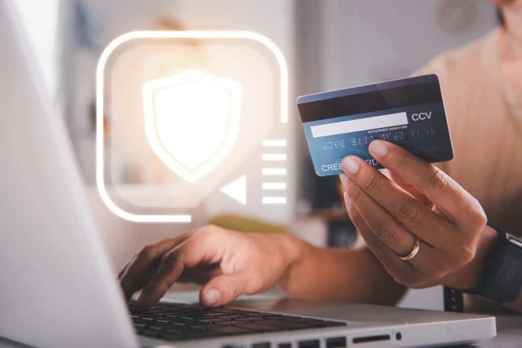 woman hands holding credit card using laptop with product purchase home scaled